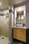 Adjoining bath to the third bedroom with step in shower